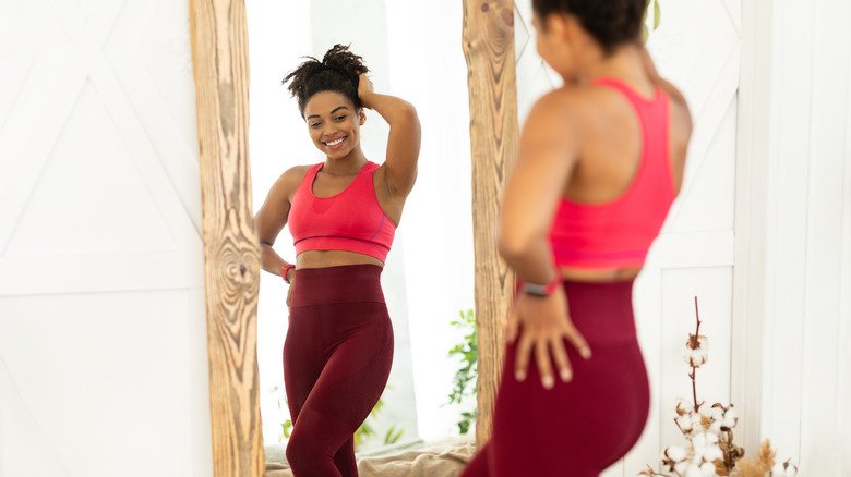 une femme posant devant le miroir