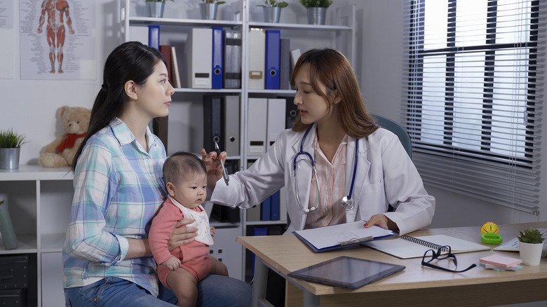 Parent avec bébé et médecin