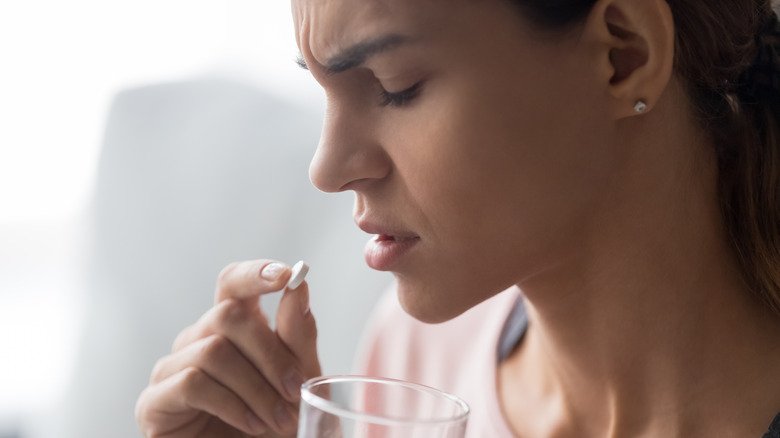 Une femme malheureuse qui prend la pilule