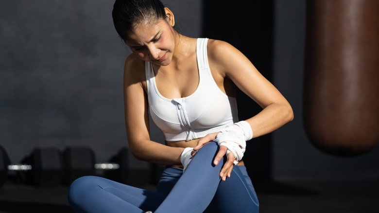 femme en forme soignant sa douleur au genou