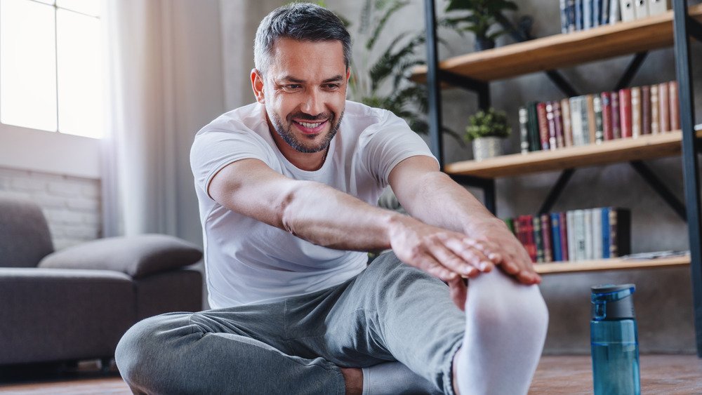 Un homme fait du yoga à la maison