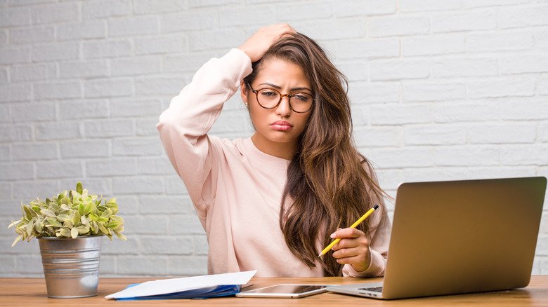 femme devant l'ordinateur qui lutte pour réfléchir