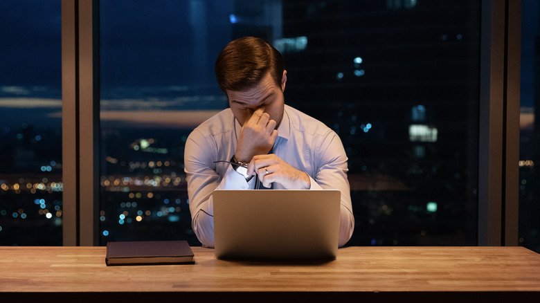 Un homme qui a du mal à effectuer des tâches de travail