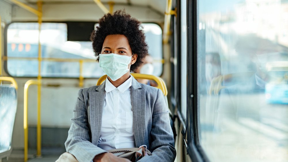 femme portant un masque facial dans un bus