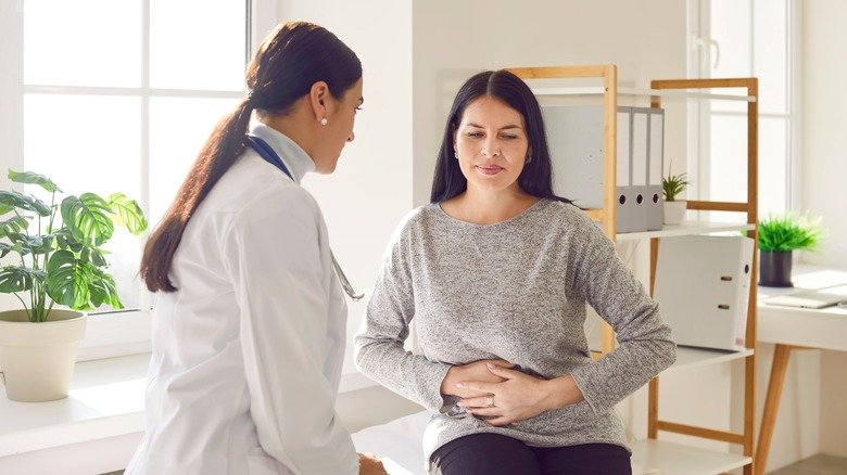 Une femme parle à son médecin de ses problèmes abdominaux