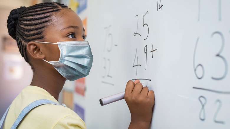 Un enfant portant un masque en classe